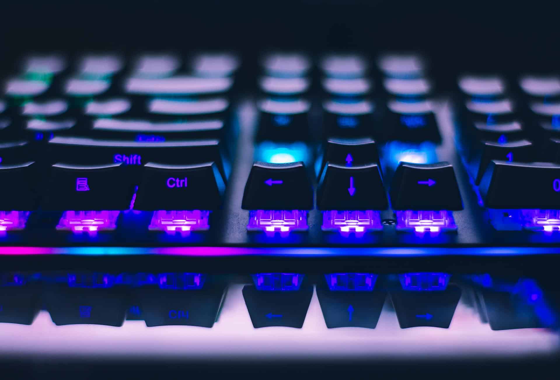 AI Office Developers. Backlit gaming keyboard with blue and purple LED lighting for professional office and gaming setups.
